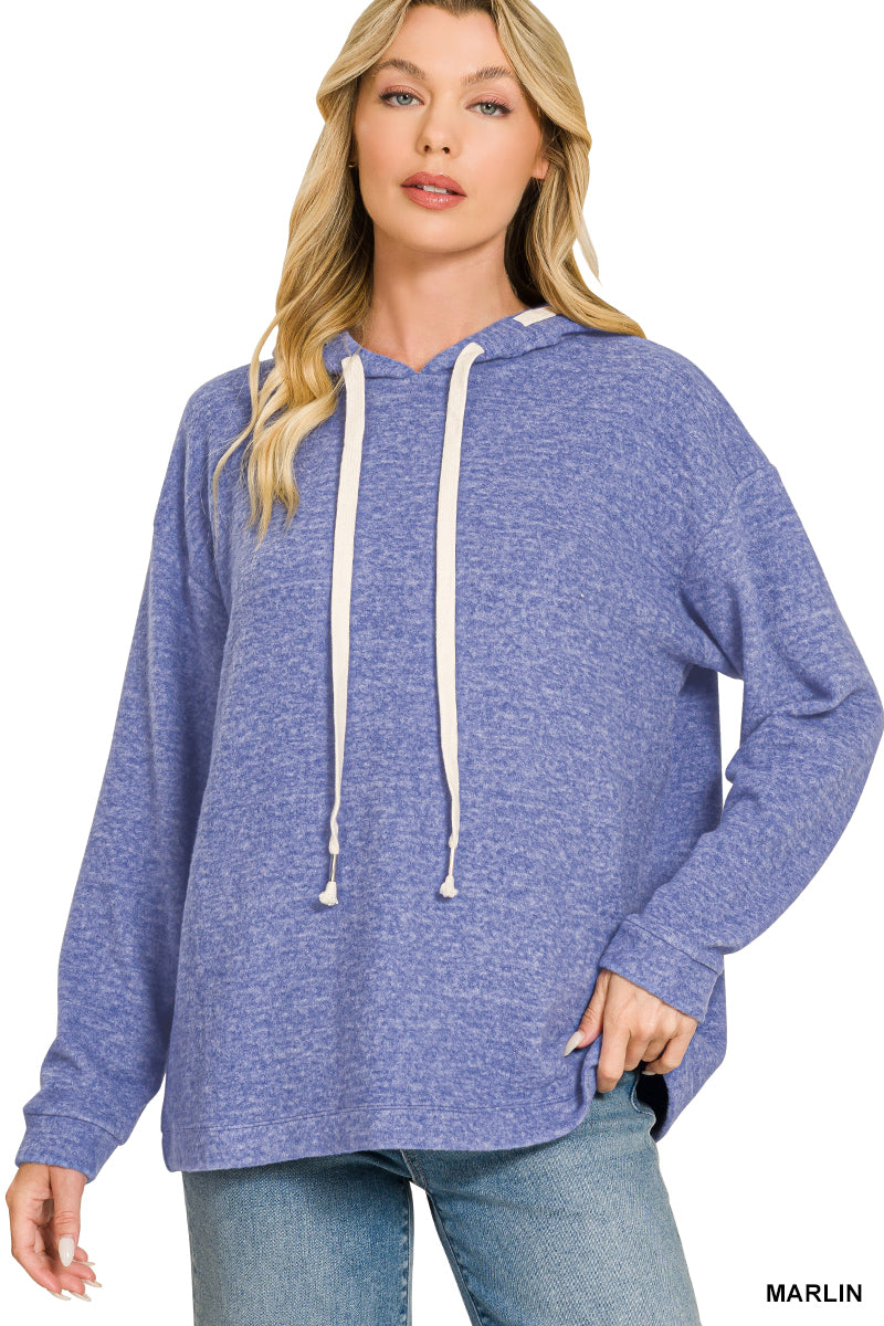 Woman wearing royal blue hoodie with jeans on a white background
