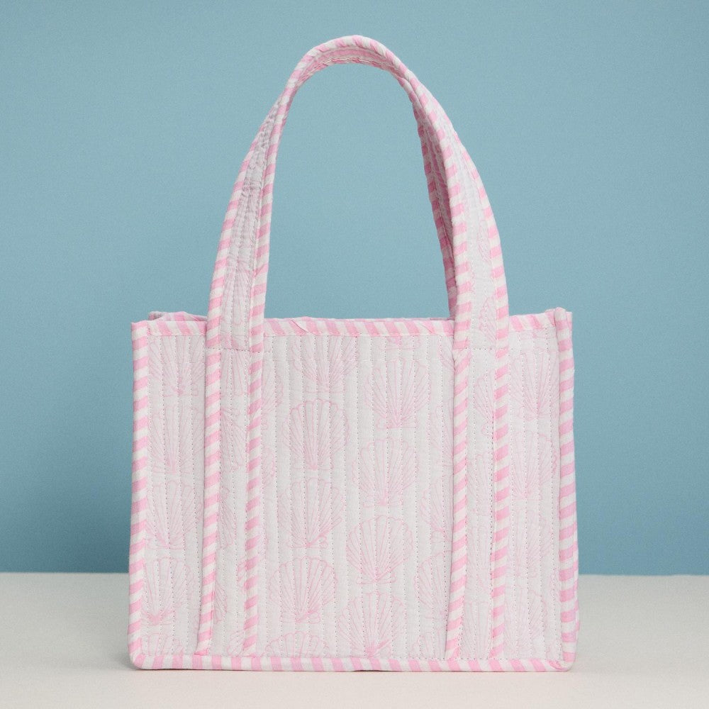 Pink and white textured tote bag on a light blue background