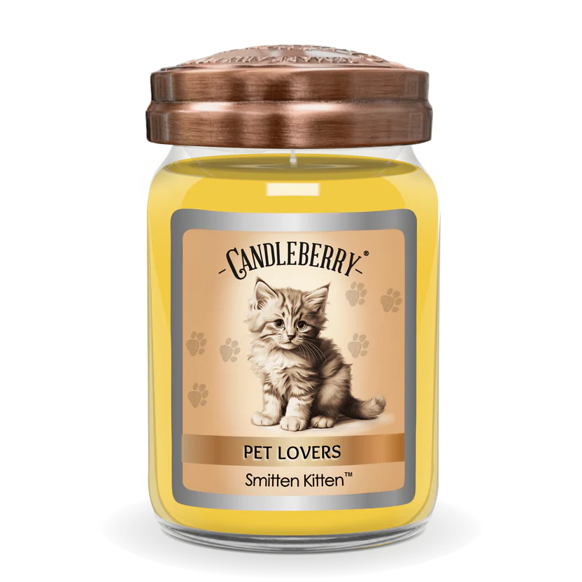 A yellow jar candle with a kitten design on the label, titled 'Pet Lovers' and named 'Smitten Kitten'. The lid of the jar is copper-colored.