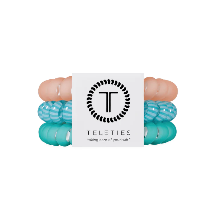 Set of three hair ties that are coral, green and striped. 