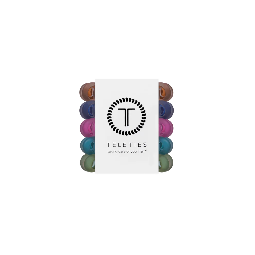 A pack of Teleties hair care caps shown in a vertical stack with a white paper sleeve featuring the black Teleties logo and the text 'taking care of your hair'. The caps visible on the sides are in multiple colors including brown, purple, pink, blue, and green.