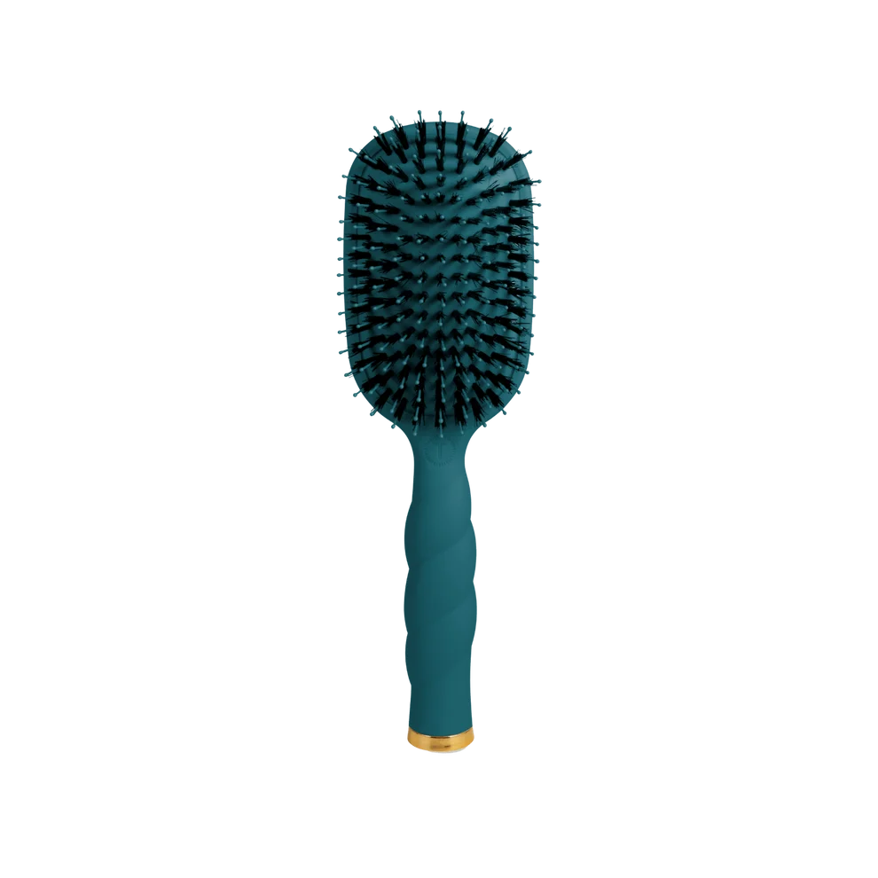 A paddle hairbrush with a dark teal handle and bristles, featuring a small gold accent ring near the base, isolated on a white background.