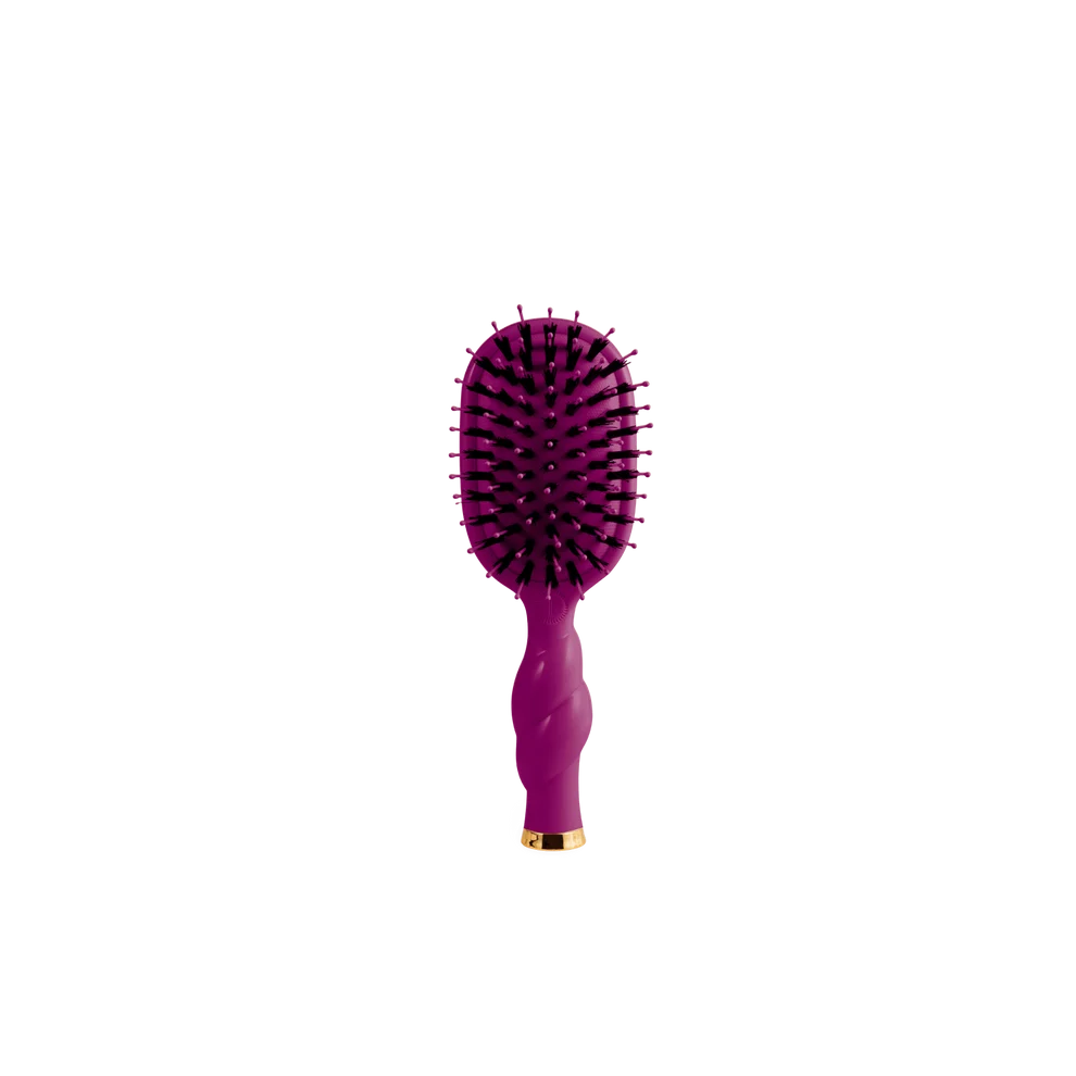 A purple oval hairbrush with black bristles and a gold accent at the base, centered on a plain white background.