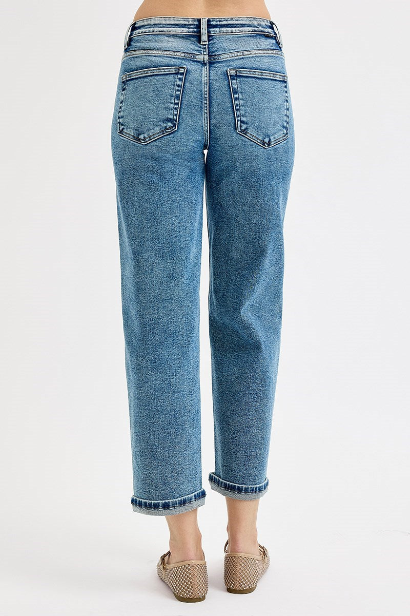 Blue jeans worn by a person on a white background