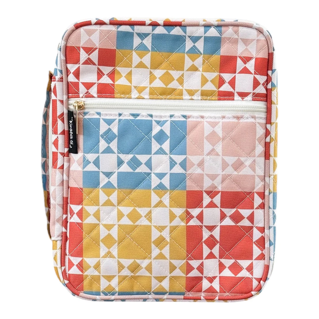 Colorful quilted Bible cover with geometric pattern on a white background