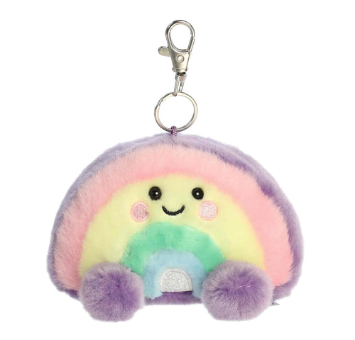 A pastel rainbow plush keychain with a silver lobster clasp, featuring a smiling face and pom-pom feet on a white background.