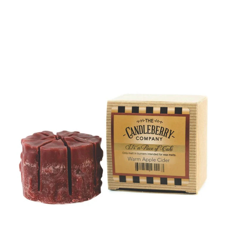 A red wax melt designed to resemble a tart, placed next to its packaging box which reads 'Candleberry Company' and 'Warm Apple Cider'.