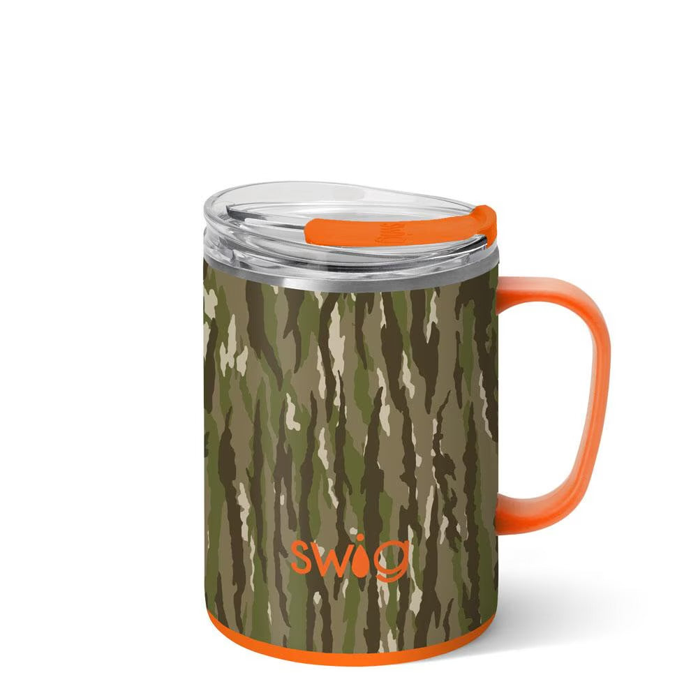 A stainless steel insulated mug with a brown and green tree bark camouflage pattern, featuring an orange handle, orange base trim, and an orange lid release. The SWIG logo is printed in orange near the bottom.