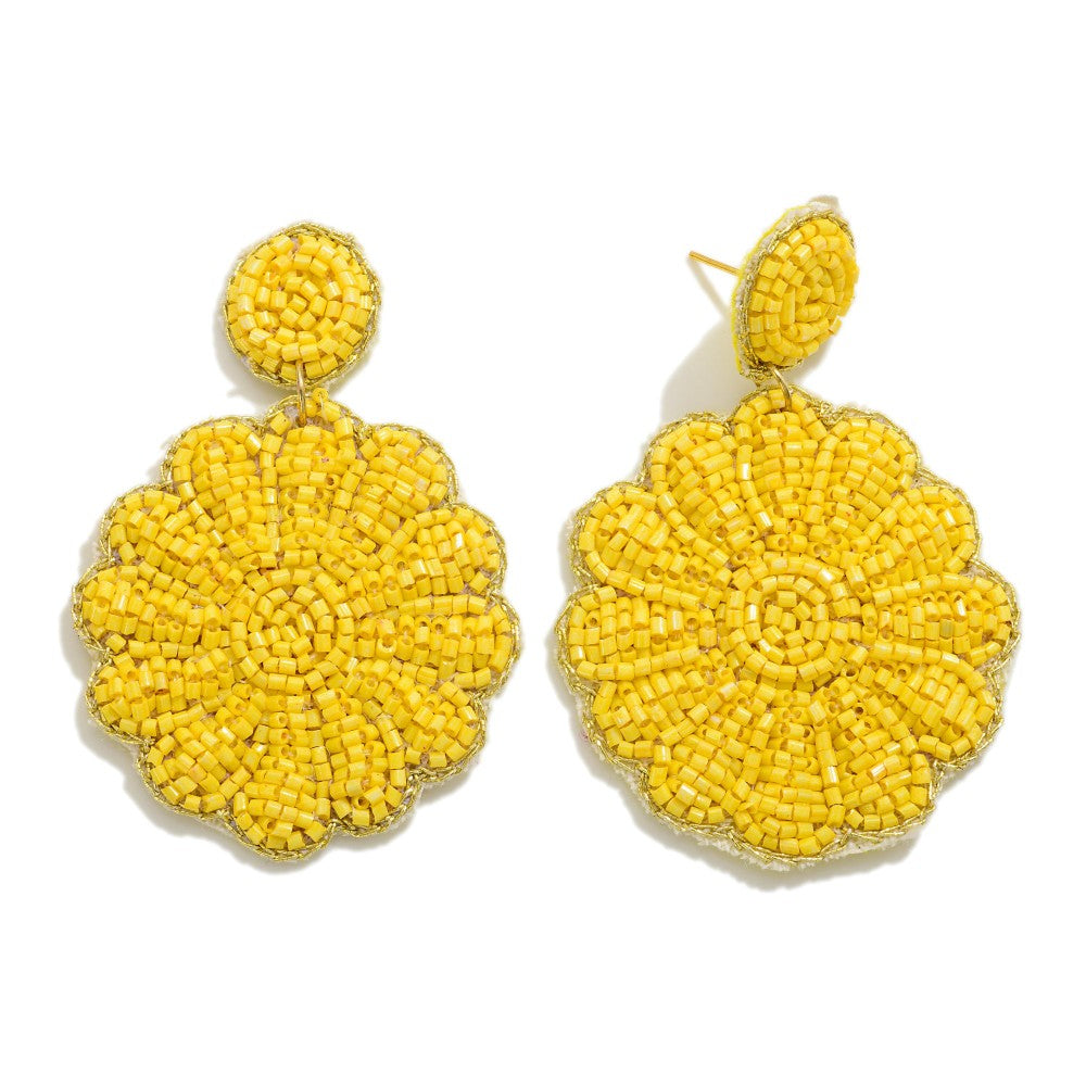 Pair of yellow beaded earrings on a white background