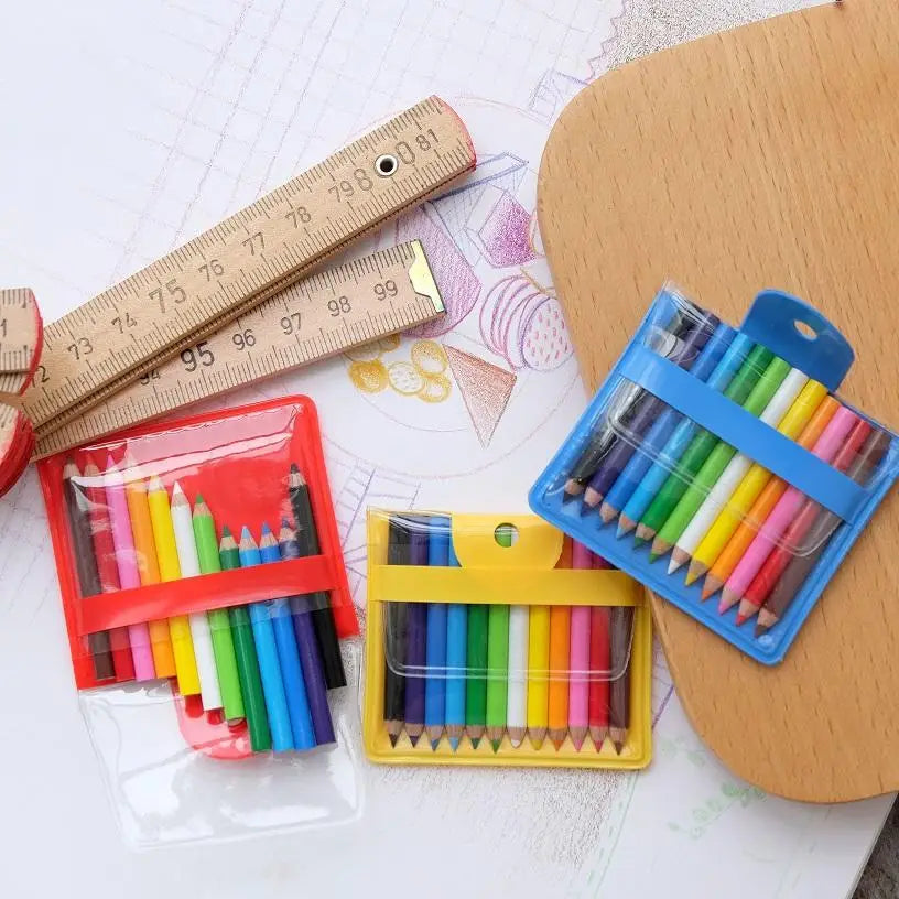 Set of colorful pencils in transparent cases on a white surface with a wooden ruler.