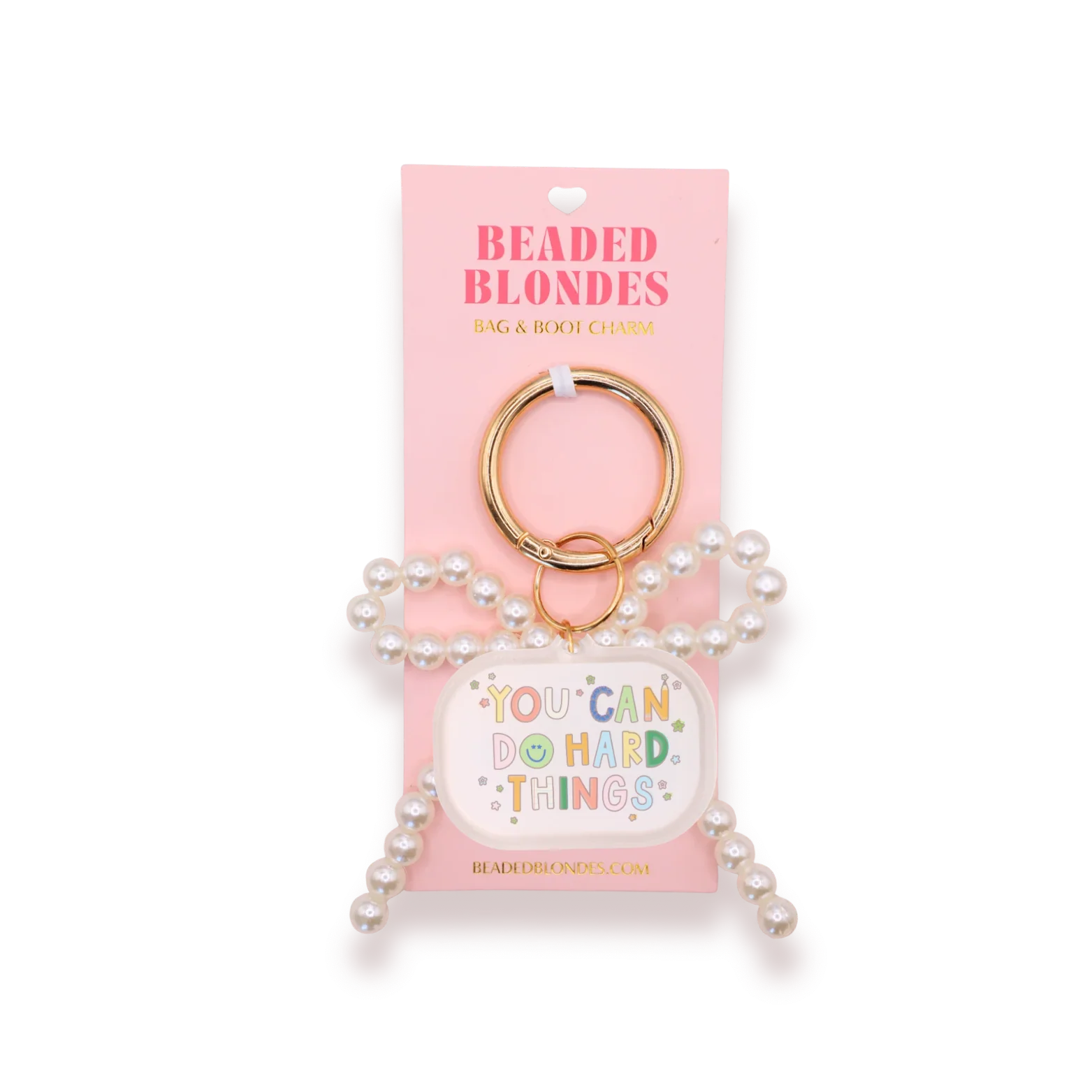 A pearl-beaded bag and body charm keychain with a gold key ring, displayed on its pink retail backing card. The charm features a white oval tag with the colorful text 'YOU CAN DO HARD THINGS' surrounded by small decorative dots.