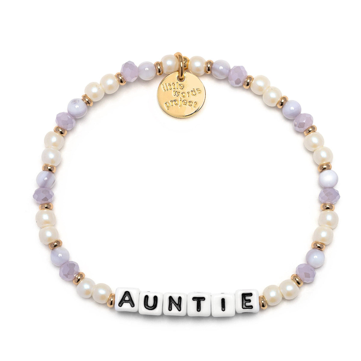 A beaded stretch bracelet on a clean off-white background. The bracelet features white faux pearls, lavender faceted beads, gold spacer beads, a round gold charm engraved with 'This bracelet belongs', and white letter tiles spelling 'AUNTIE' at the front.