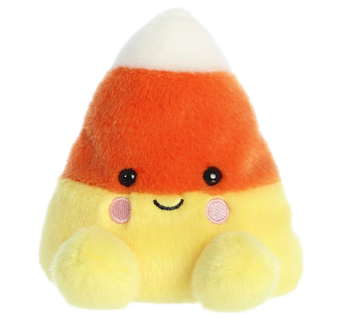 A cute, soft plush toy shaped like a candy corn with a smiling face, featuring orange, yellow, and white colors, set against a plain white background.
