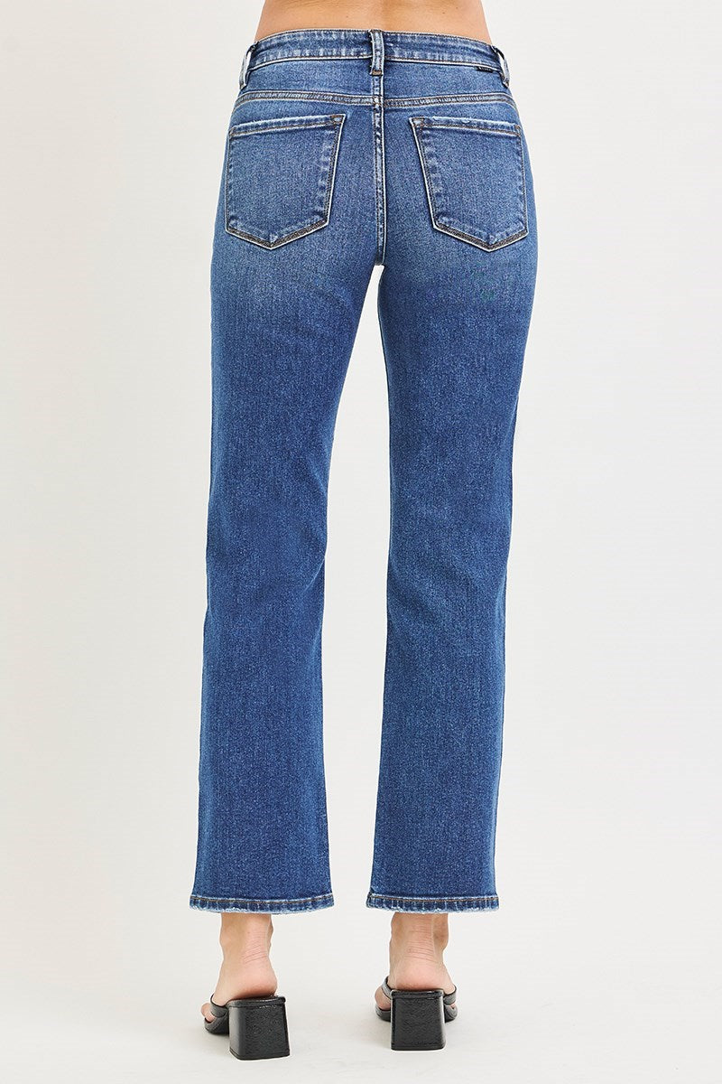 Blue jeans worn by a person on a white background